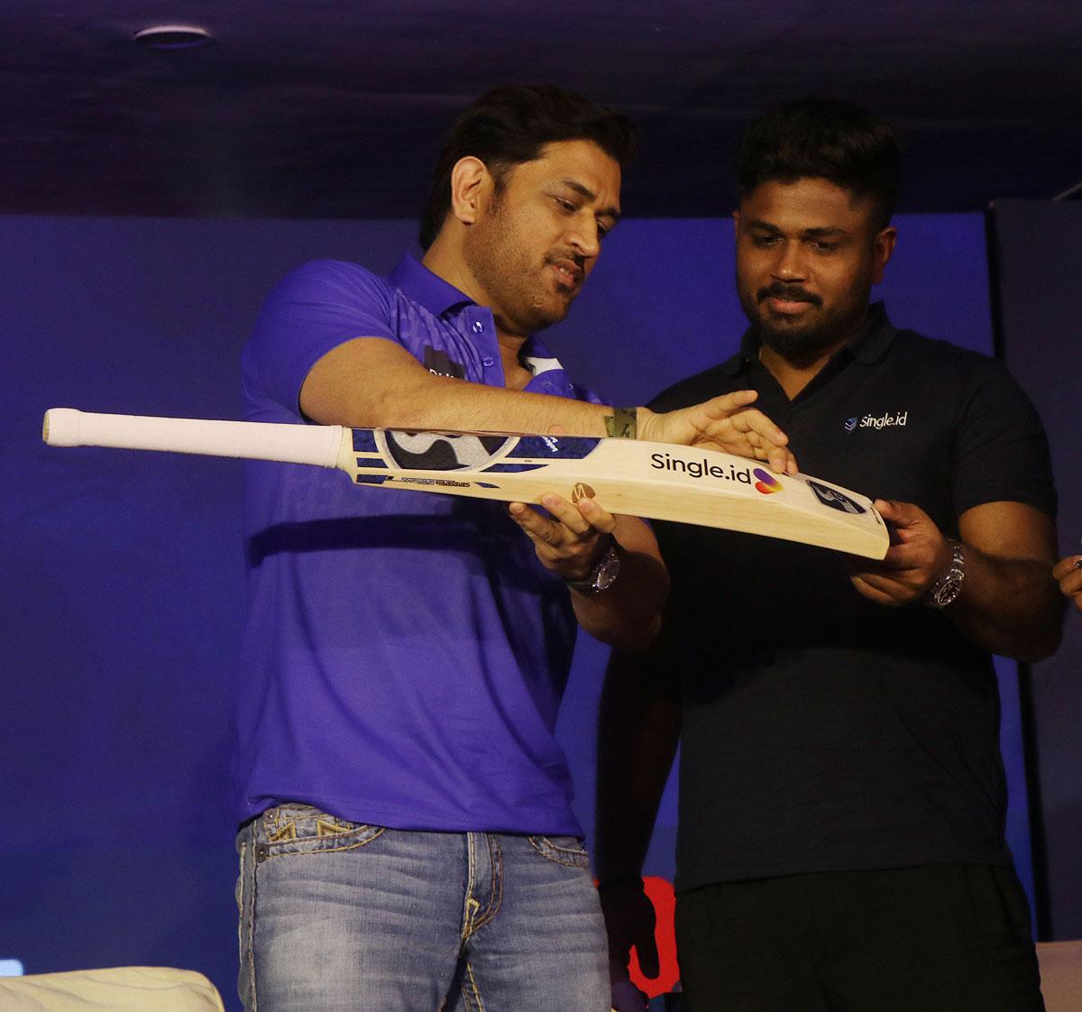 Mahendra Singh Dhoni and Sanju Samson sign a bat 