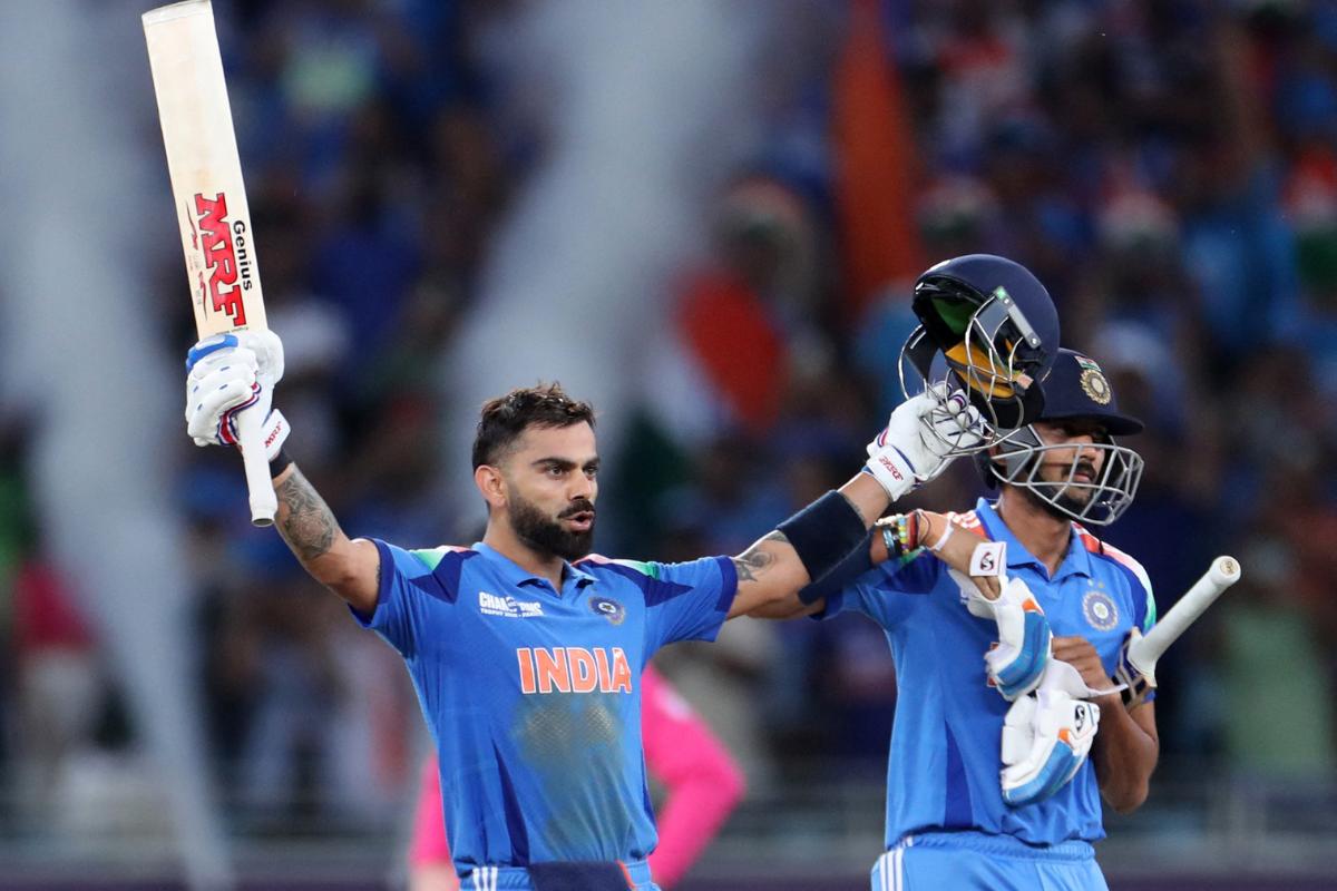 India's Virat Kohli celebrates after hitting four runs to reach his century and win the match against Pakistan on Sunday