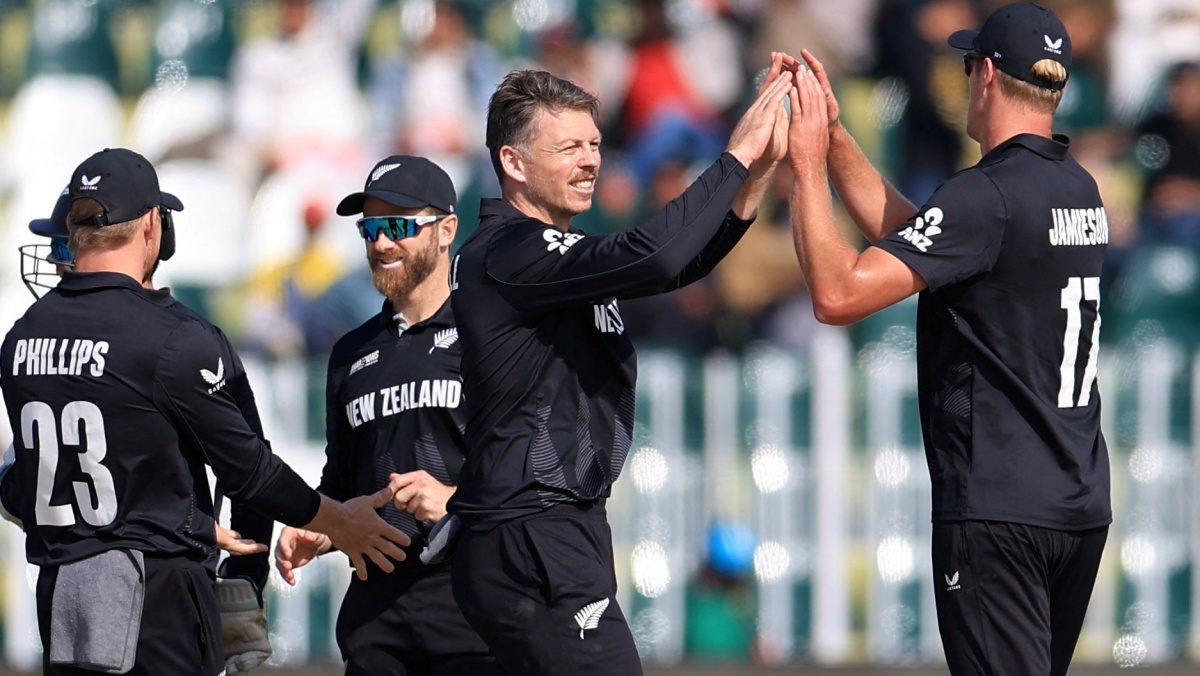 New Zealand's Michael Bracewell celebrates with teammates after taking the wicket of Bangladesh's Tanzid Hasan, caught out by Kane Williamson 