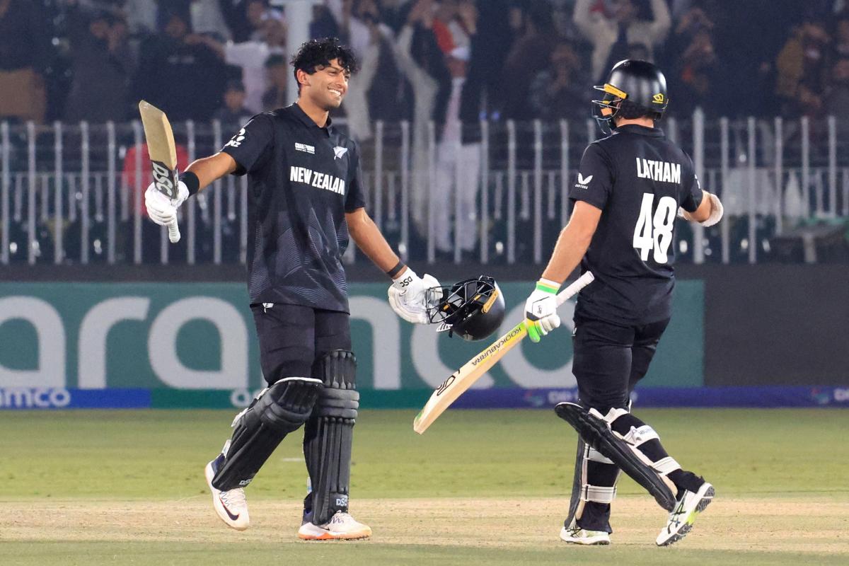 New Zealand's Rachin Ravindra celebrates with Tom Latham on reaching his century