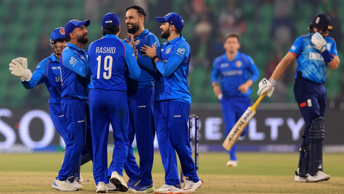 Afghanistan's Mohammad Nabi celebrates with teammates after taking the wicket of England's Harry Brook