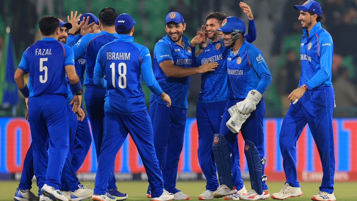 Afghanistan's Azmatullah Omarzai celebrates with teammates after taking a catch to dismiss England's Jamie Smith off the bowling of Mohammad Nabi 