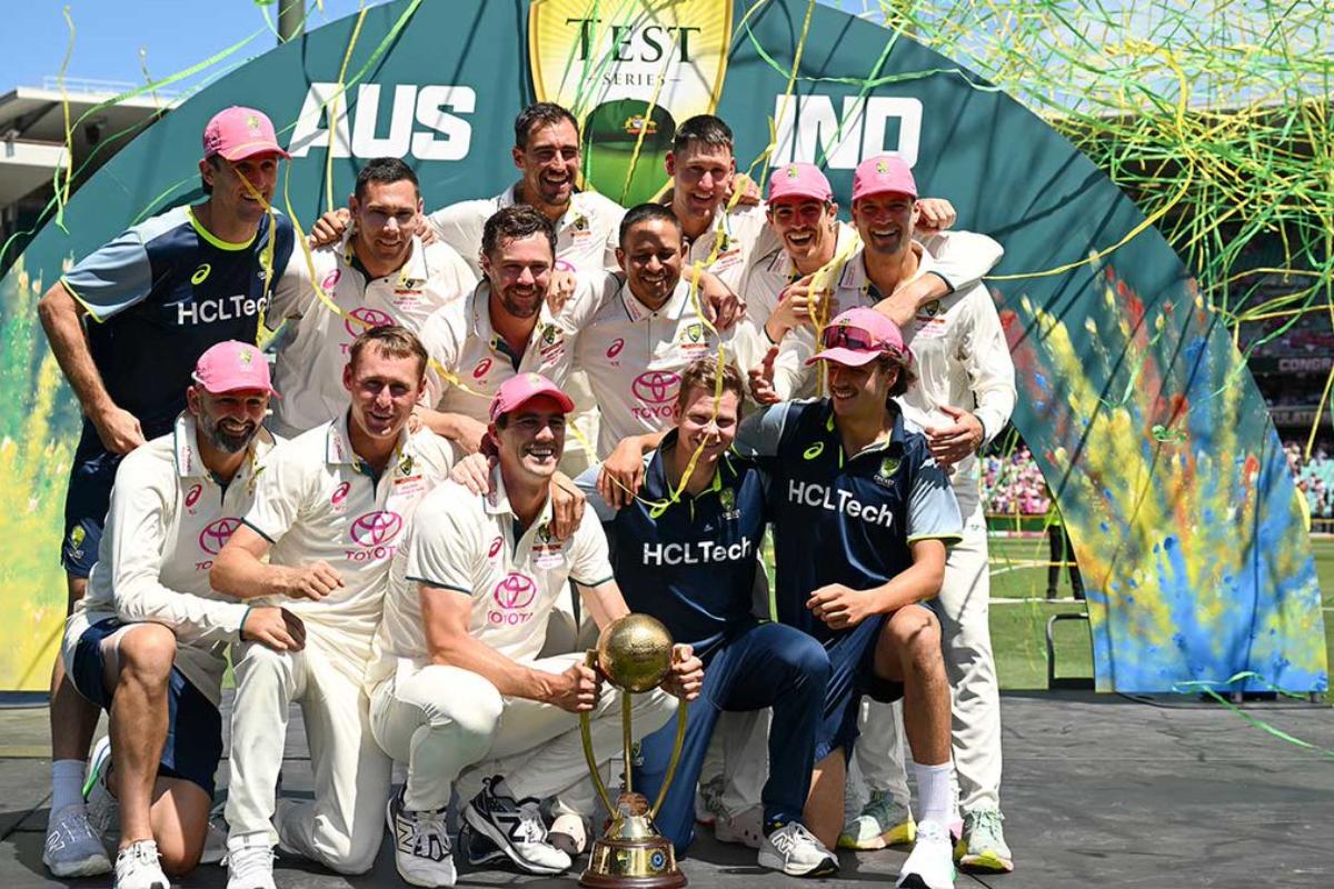 Pat Cummins and his victorious teammates pose with their prized possession