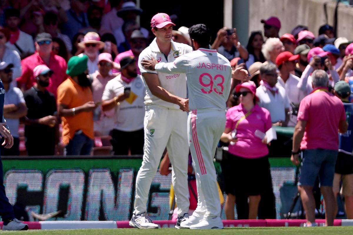 Pat Cummins is congratulated by Jasprit Bumrah