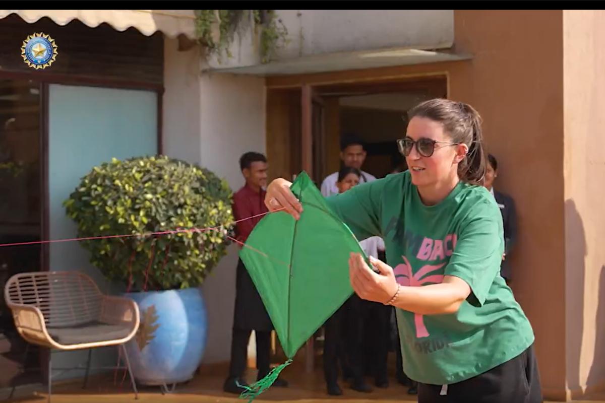 An Irish cricketer gets ready to lift a kite