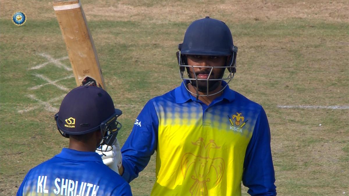 Karnataka's Smaran Ravichandran celebrates his century. 