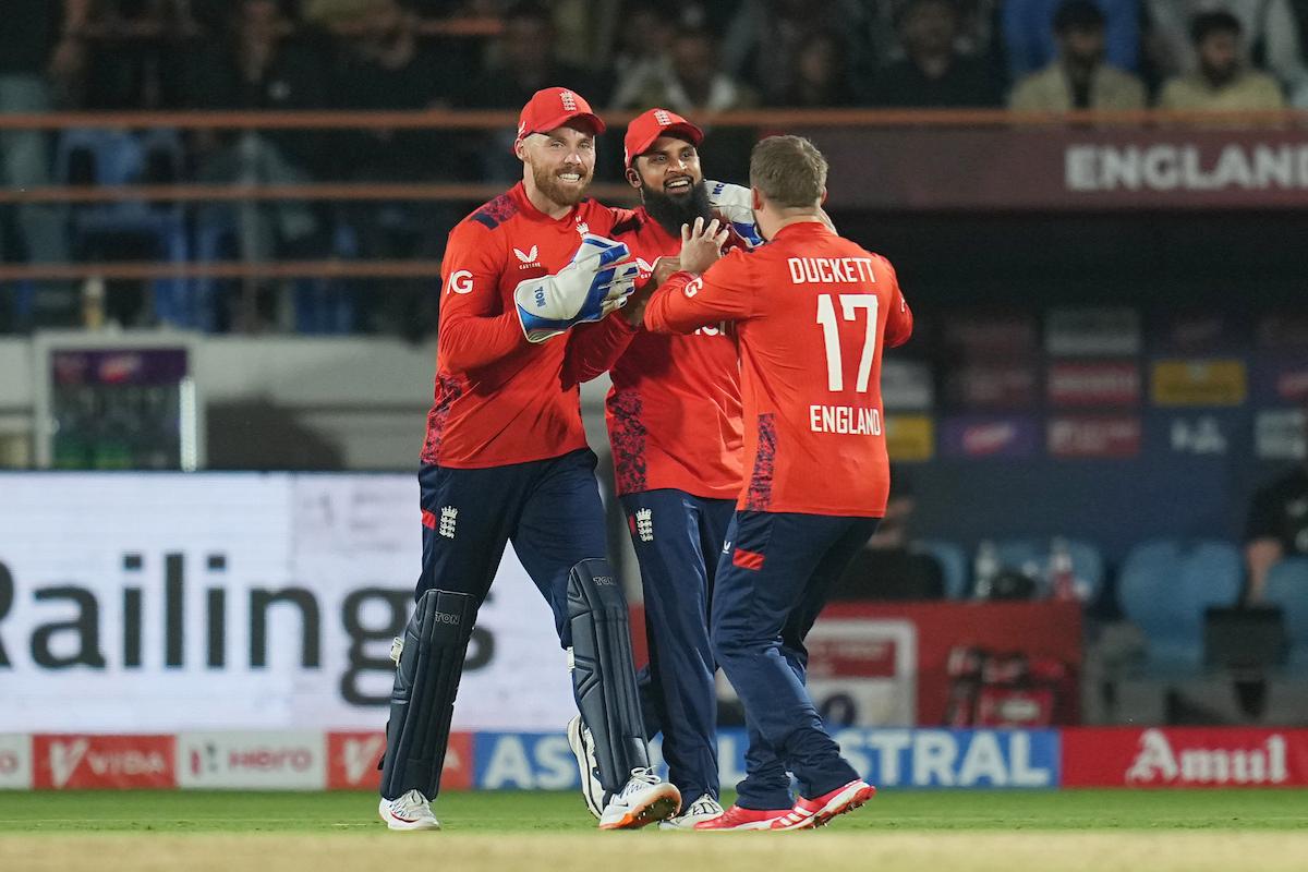 England's Phil Salt and Adil Rashid celebrate the wicket of Axar Patel 