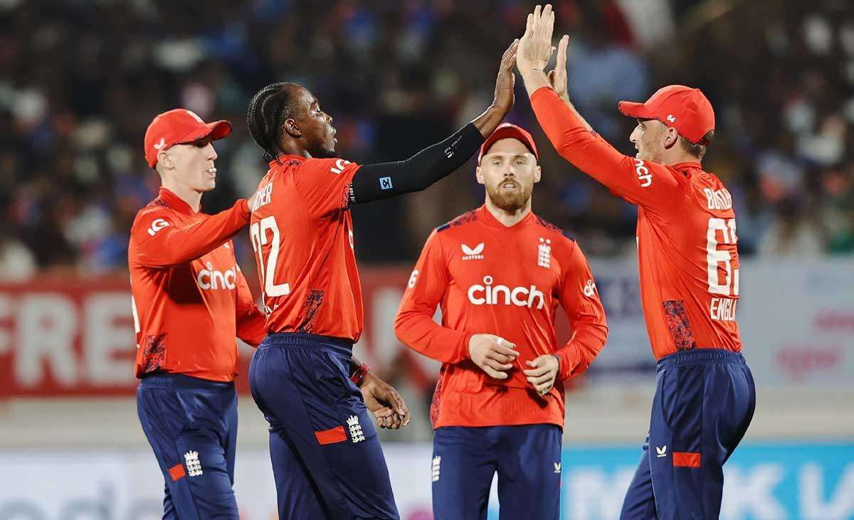 England's players celebrate with  Jofra Archer after dismissing Sanju Samson.