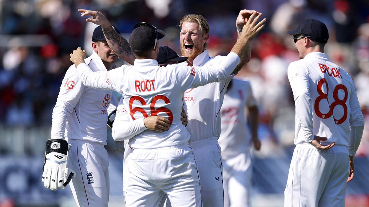 England's Ben Stokes celebrates with teammates after taking the wicket of India's Karun Nair, caught out by Joe Root