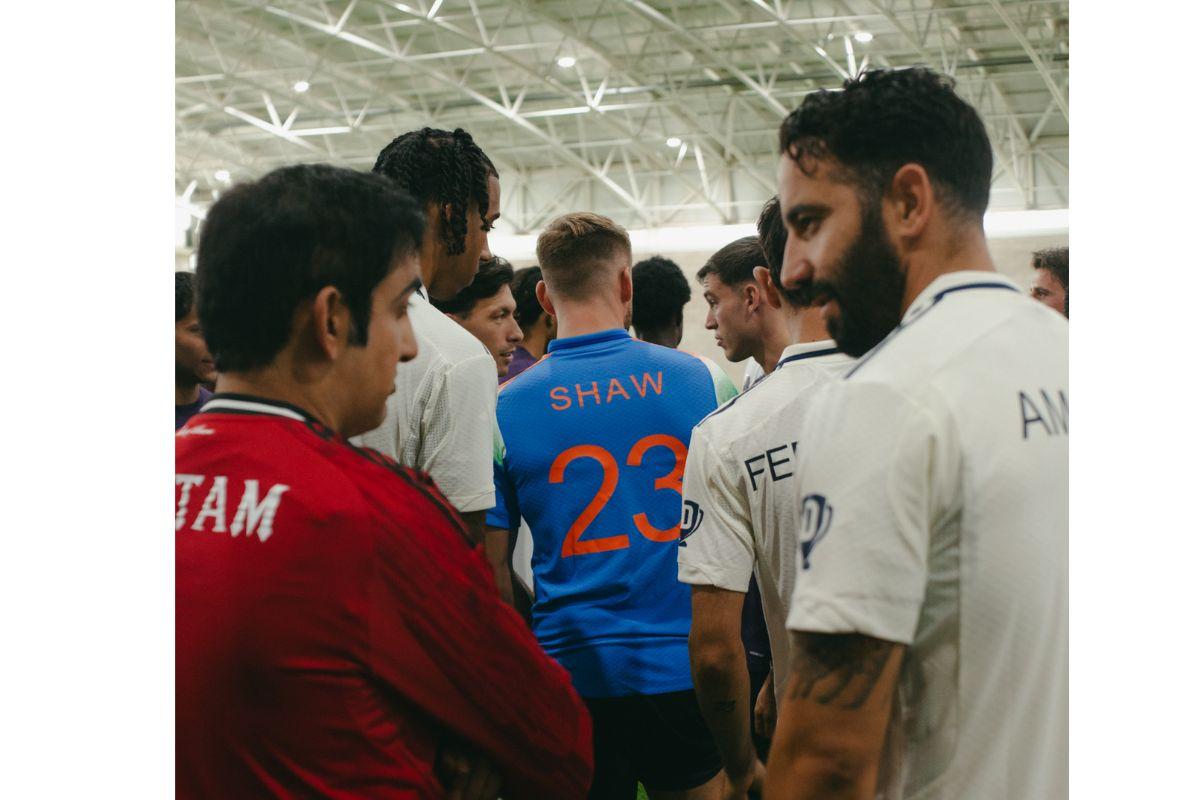 Luke Shaw looks on as Gautam Gambhir and Ruben Amorim chat