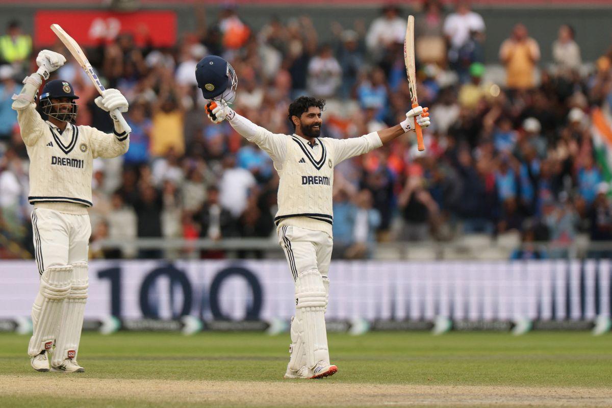India's Ravindra Jadeja celebrates after reaching his century as Washington Sundar applauds