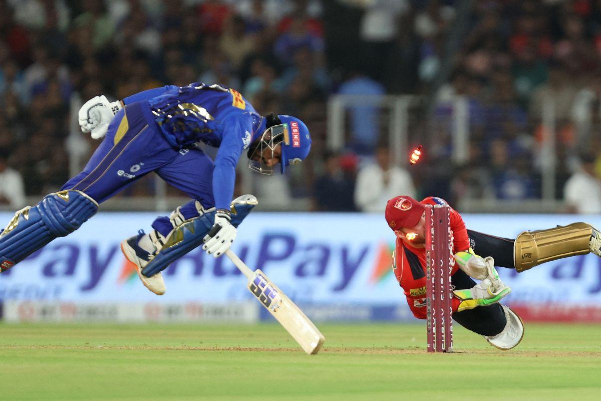 Punjab Kings' Josh Inglis attempts to run out Mumbai Indians' Tilak Varma 
