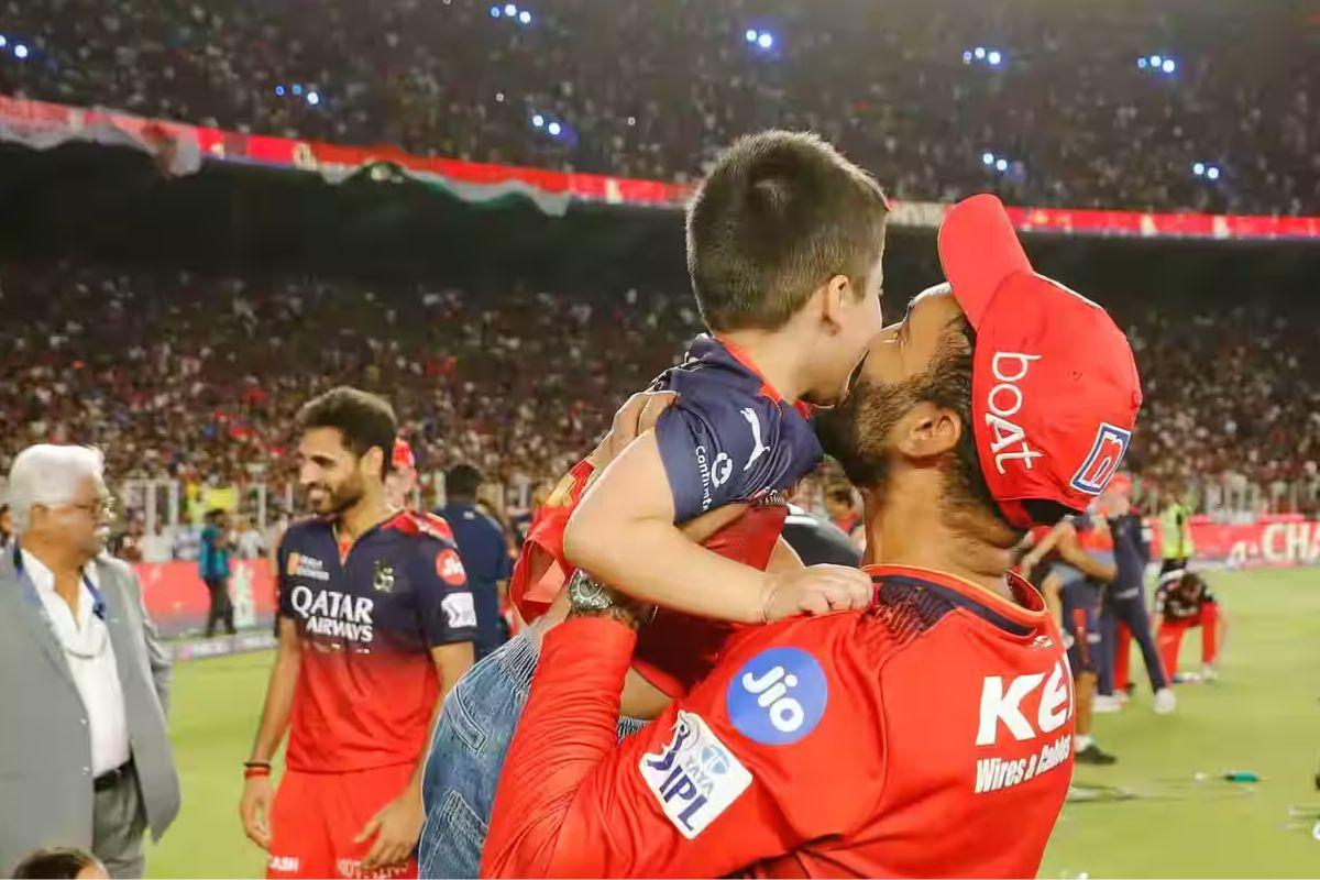 RCB batting coach Dinesh Karthik kisses his son after the win