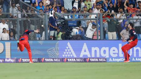Royal Challengers Bengaluru's Phil Salt and Tim David combine to catch and dismiss Deepak Chahar of Mumbai Indians during the Indian Premier League at the Wankhede stadium, Mumbai, April 7, 2025.