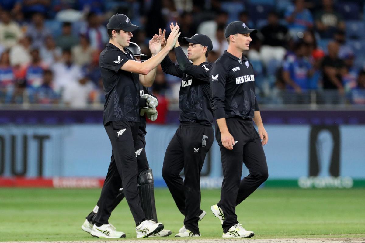 New Zealand's Will O'Rourke celebrates with teammates after taking the catch to dismiss Axar Patel off Michael Bracewell