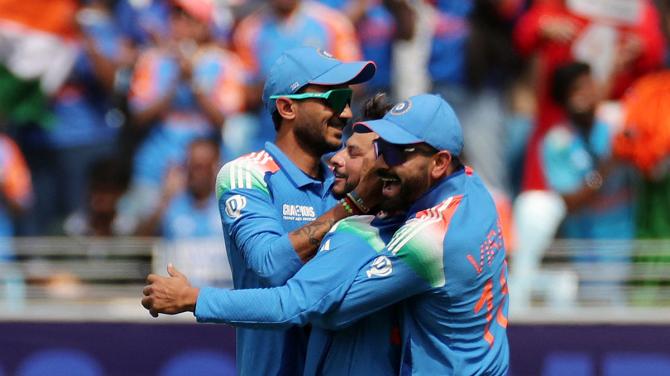 Kuldeep Yadav celebrates with teammates after taking the caught and bowled wicket of New Zealand's Kane Williamson