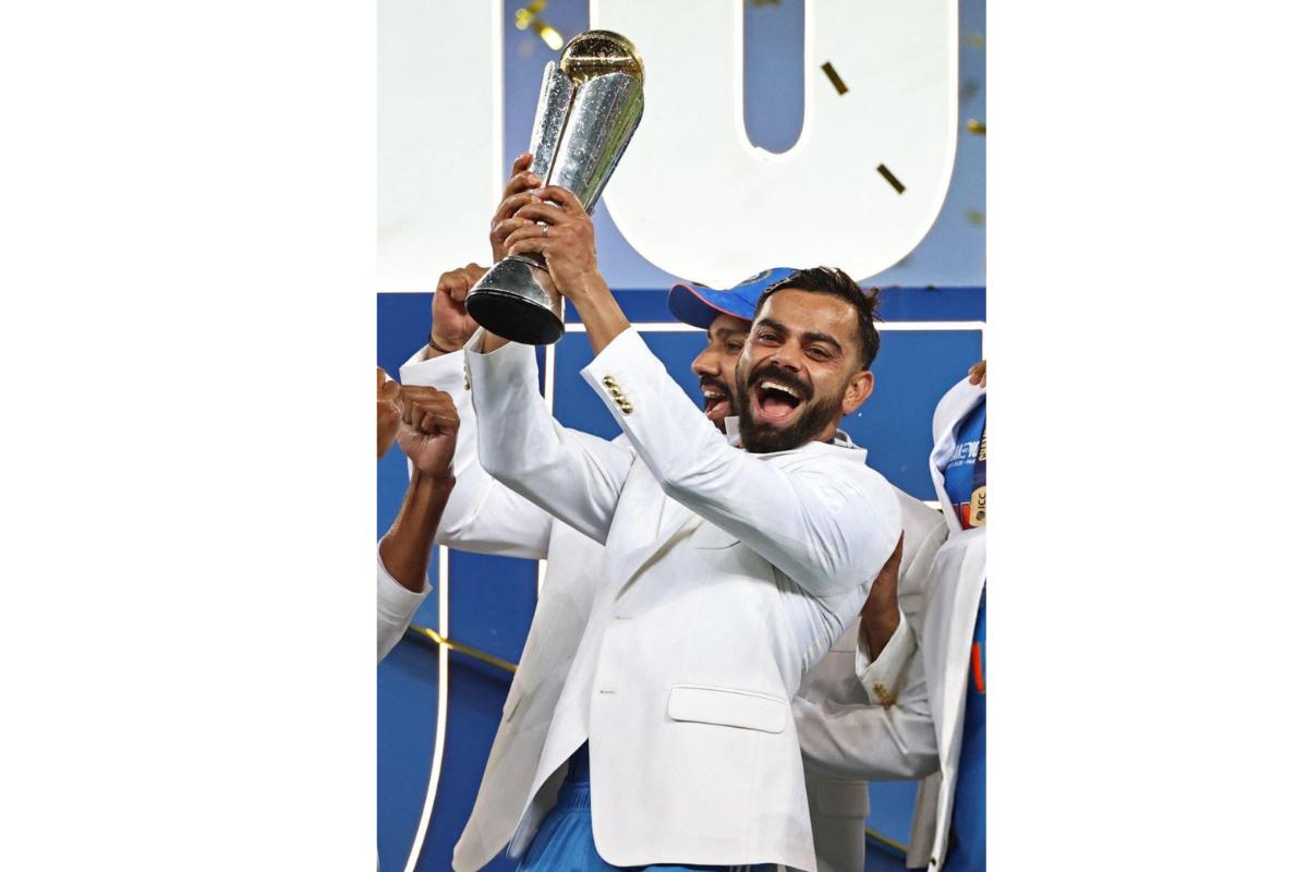 Virat Kohli celebrates with the trophy after winning the Champions Trophy on Sunday, March 9