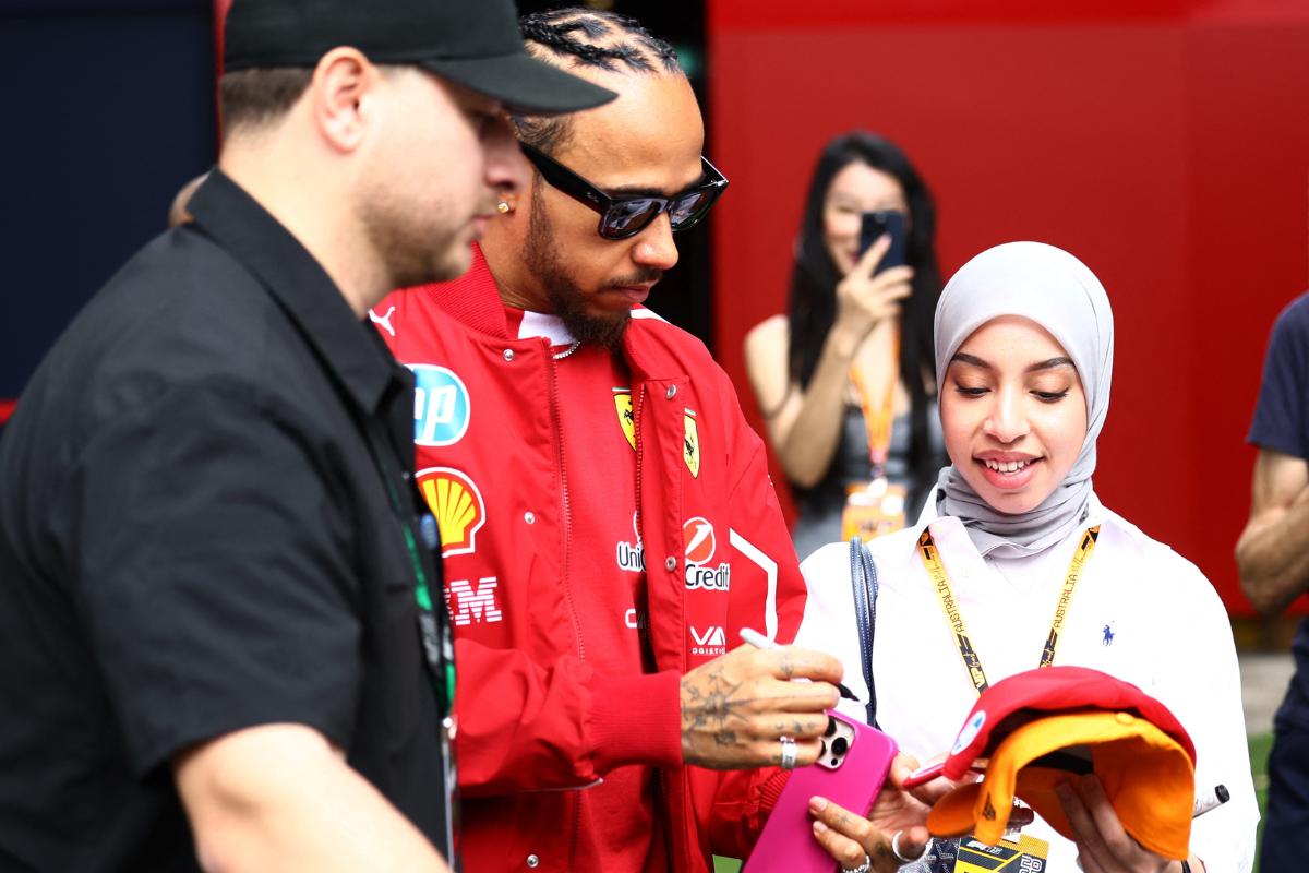 Ferrari's Lewis Hamilton signs autographs for fans at the Albert Park Grand Prix Circuit on Thursday ahead of the Australian Grand Prix