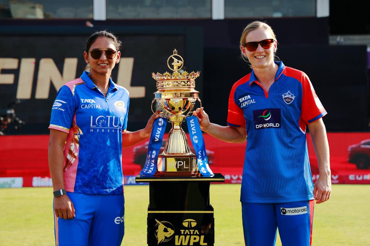 Mi captain Harmanpreet Singh and Delhi Capitals' captain Meg Lanning with the WPL trophy in Mumbai on Friday