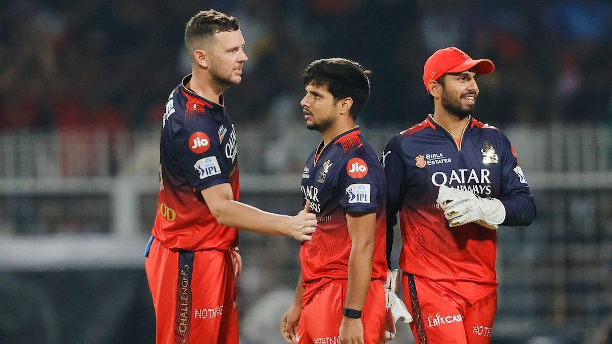 Rasikh Dar gets a high-five from Josh Hazlewood as Royal Challengers Bengaluru celebrate the wicket of Kolkata Knight Riders batter Sunil Narine during the Indian Premier League 2025 opener at Eden Gardens, Kolkata, on Saturday.