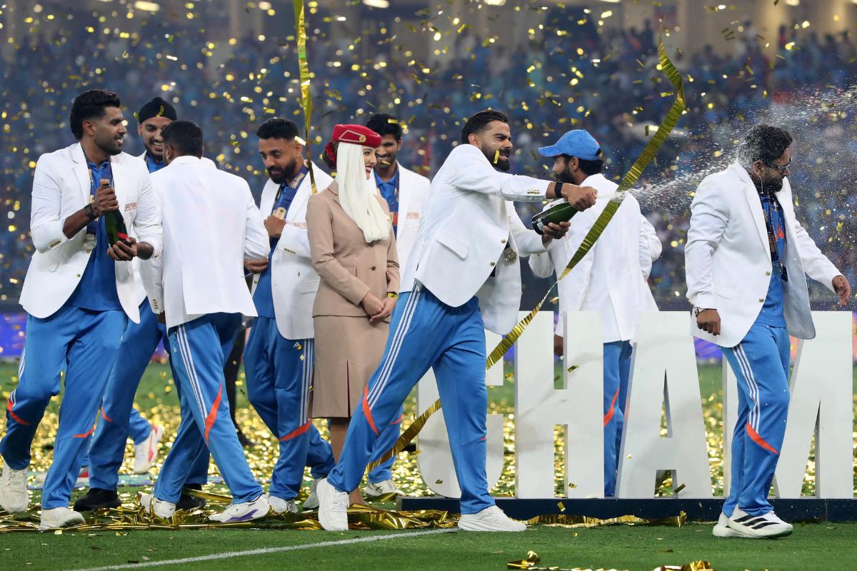 Virat Kohli sprays champagne on teammates after winning the ICC Champions Trophy on Sunday