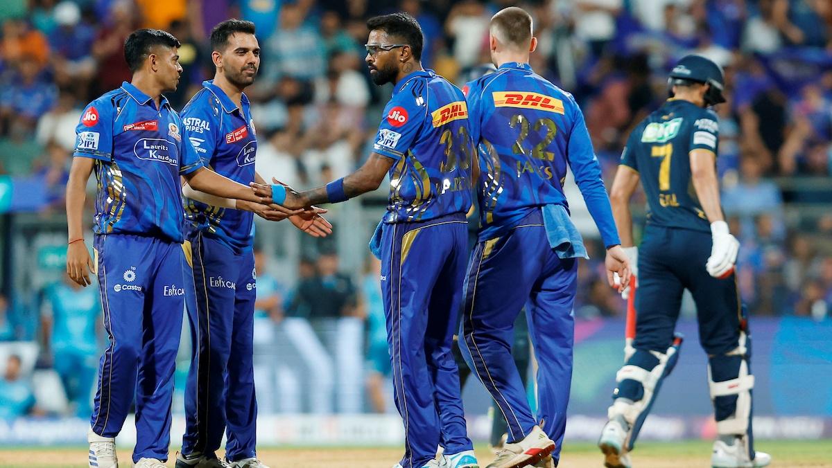 Mumbai Indians players celebrate the dismissal of Jos Buttler.