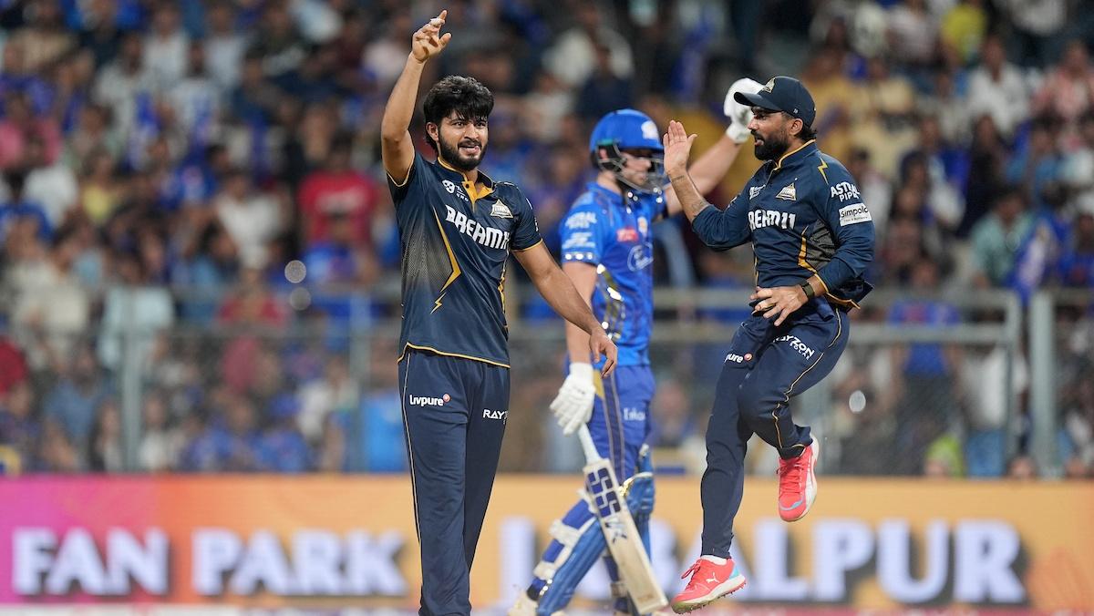 Arshad Khan celebrates the wicket of Rohit Sharma.