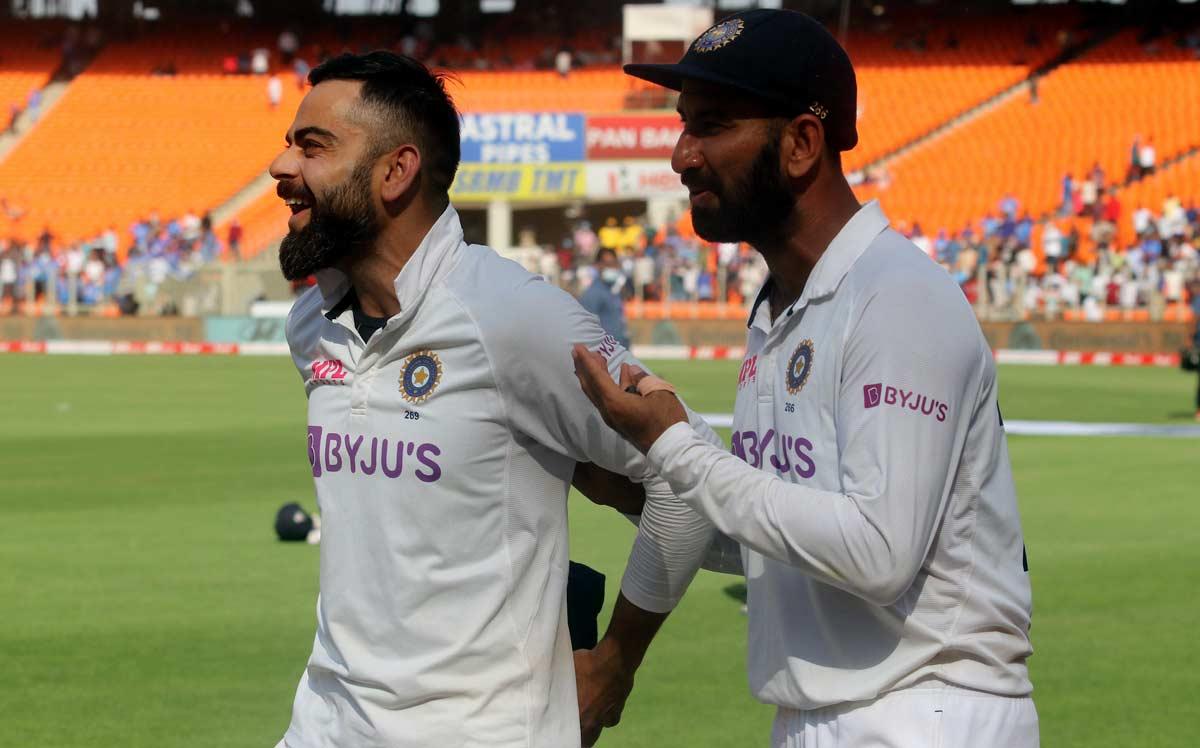 Virat Kohli with Cheteshwar Pujara Virat Kohli with Cheteshwar Pujara