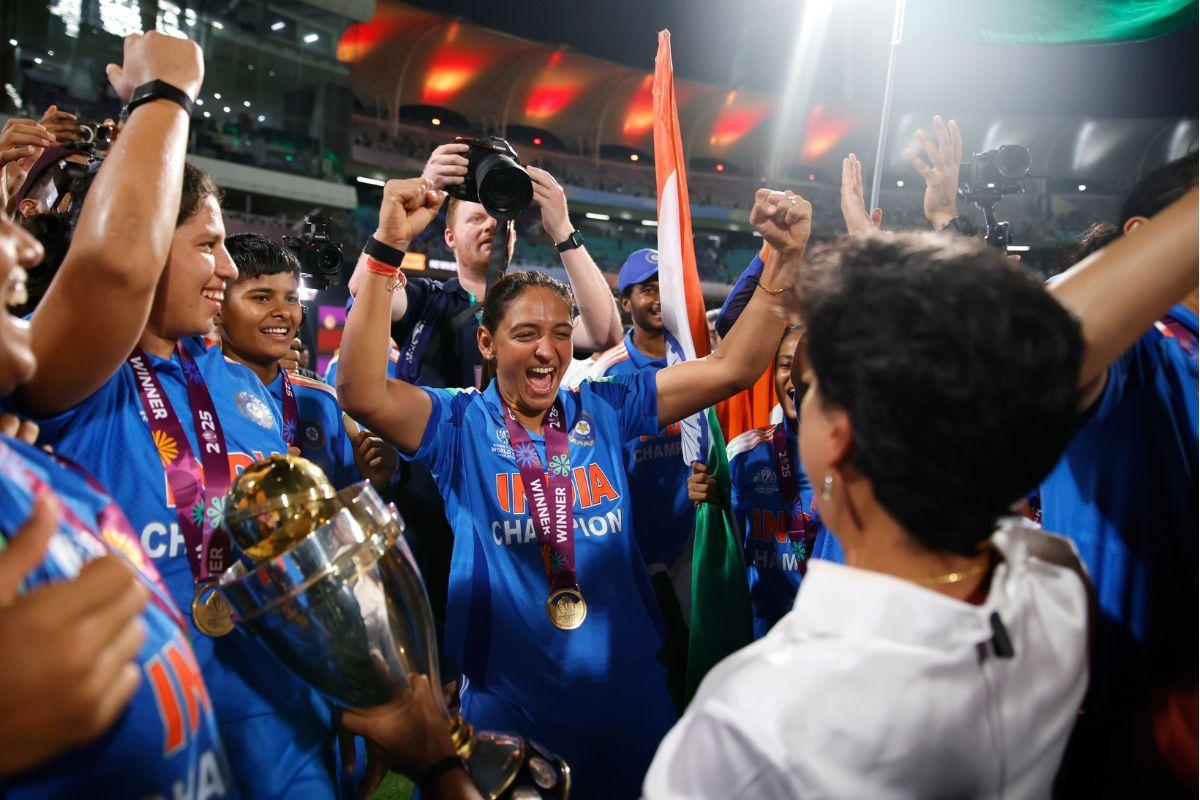 Anjum Chopra celebrates with Harmanpreet Singh and teammates