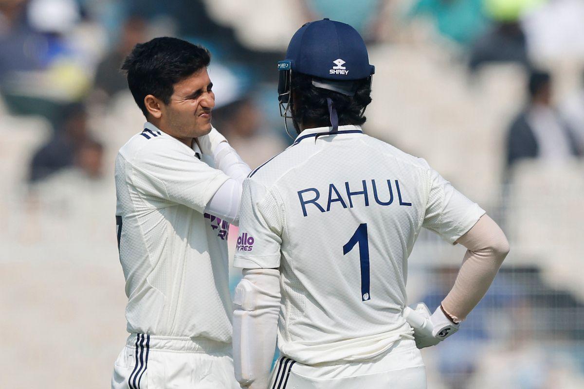 Shubman Gill holds his neck after playing a sweep shot