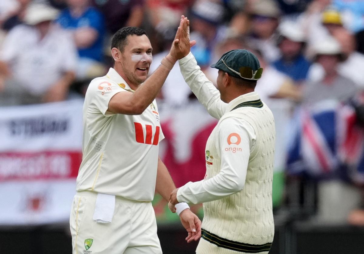 Australia pacer Scott Boland celebrates with Usman Khawaja after taking the wicket of England's Ollie Pope.