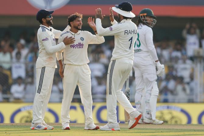 Kuldeep Yadav celebrates with his India teammates after dismissing Wiaan Mulder