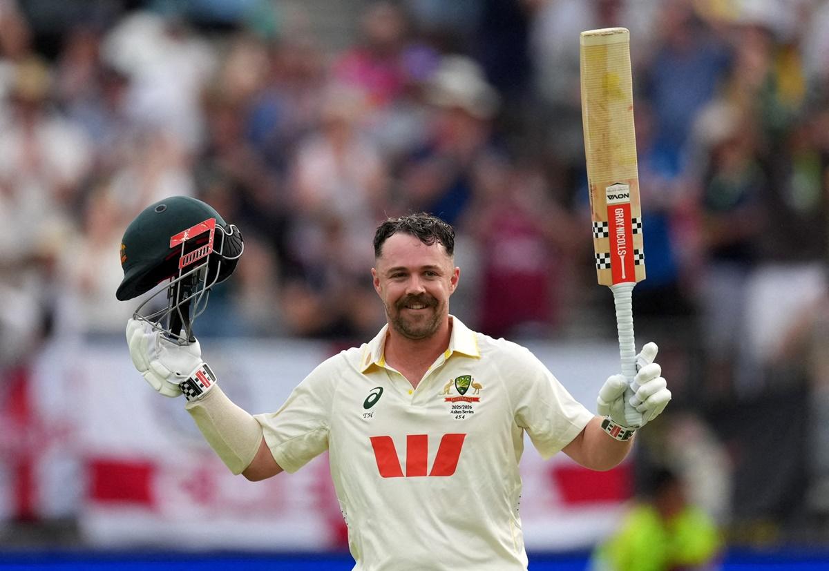 Travis Head celebrates after completing his century on Day 2 of the first Test against England in Perth on Saturday. 