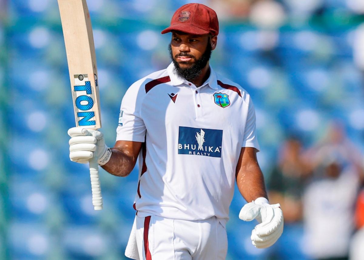 John Campbell raises his bat after reaching a half-century