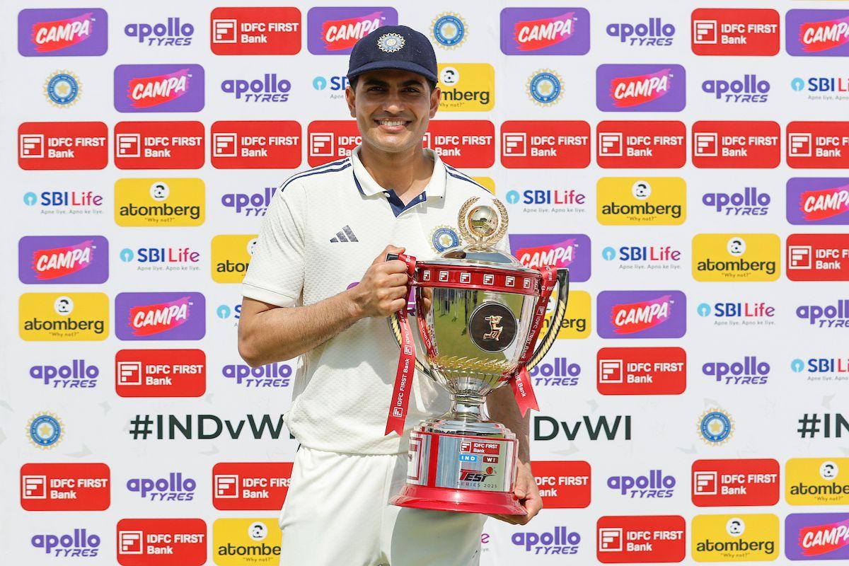 Indian captain Shubman Gill celebrates with the trophy after winning the two-match Test series against West Indies in New Delhi on Tuesday