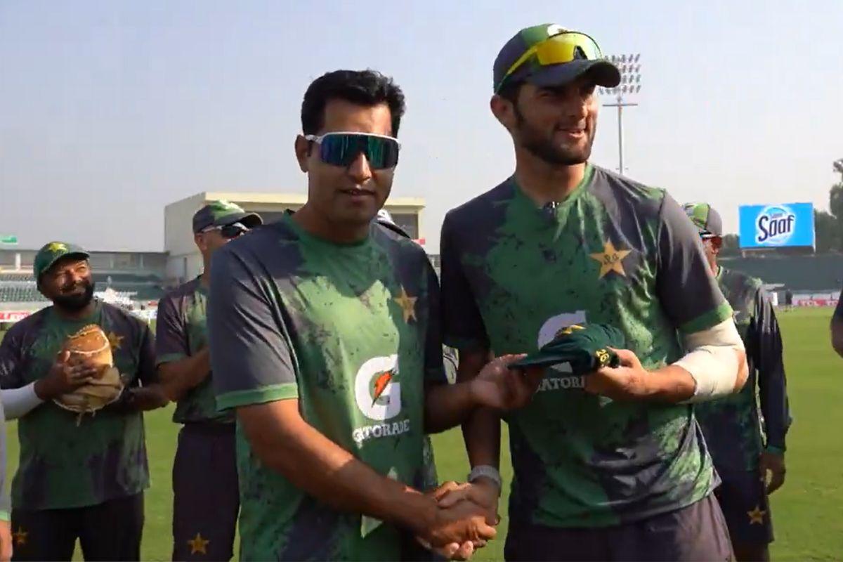 Left-arm spinner Asif Afridi is handed his Test cap by Shaheen Shah Afridi ahead of the 2nd Test against South Africa in Rawalpindi