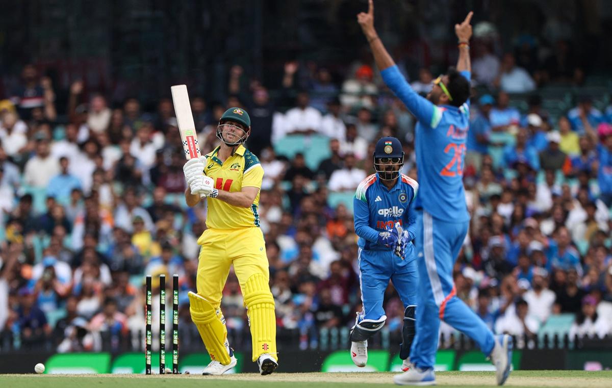 Axar Patel raises his hands in triumph after rattling the stumps of Mitchell Marsh.