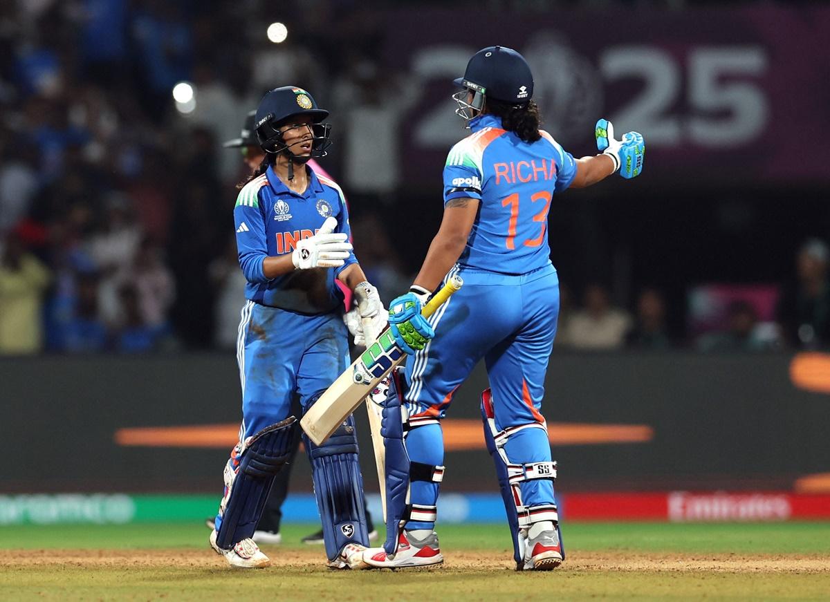 Richa Ghosh congratulates Jemimah Rodrigues on her century.