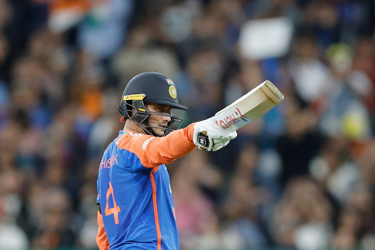 Abhishek Sharma of India raises his bat after scoring a fifty