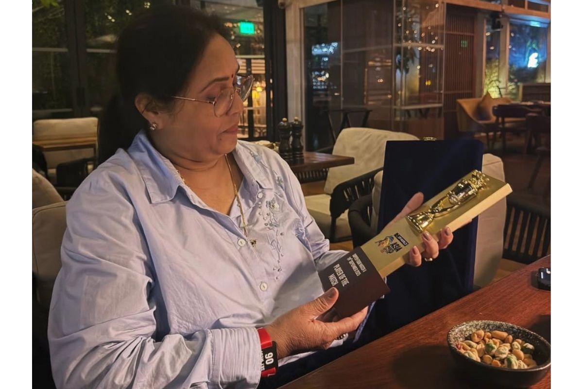 Manju Sharma with son Abhishek Sharma's Player of the Match Award, after the Super 4's match at the Asia Cup in Dubai on Wednesday