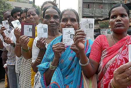Women voters show their Voter ID cards
