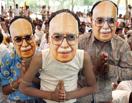 BJP supporters wear masks of party leader Advani in an election campaign rally in Biaora Madhya Pradesh on April 22