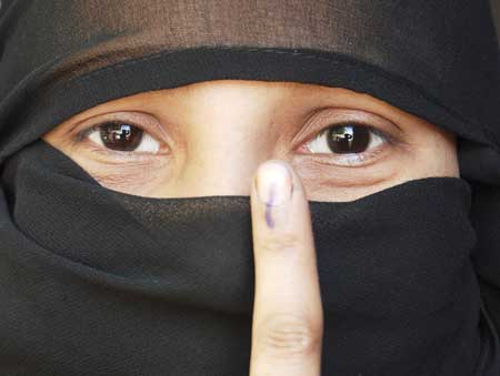 A Muslim woman voter shows her ink-marked finger after casting her ballot in Mathura on May 7, 2009