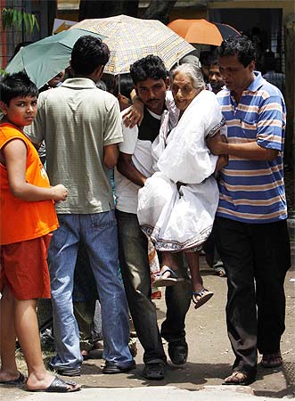 Sabita Chatterjee, 91, arrives at a polling booth in Jadavpur, south Kolkata