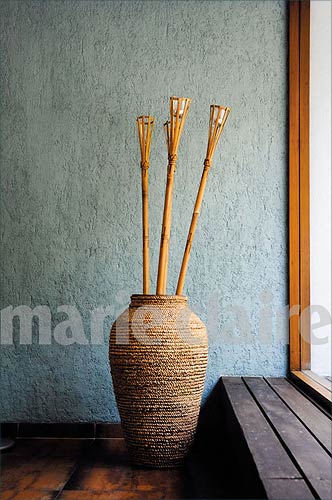 A pot sits by a window -- there isn't too much clutter around
