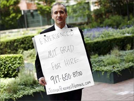 Joshua Persky, desperate to find a job, stands with his sandwich board advertisement in New York.
