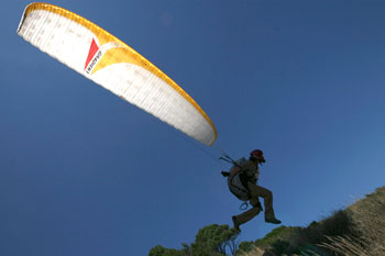A paraglider gets airbourne in windless warm contitions off Cape Town's landmark Table Mountain.