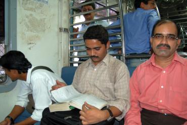 Vaibhav Hatode, centre, studies after boarding a Mumbai suburban train