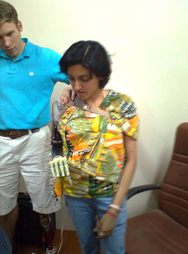 Shreya tries out a prosthetic arm