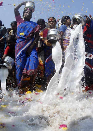 Women pour milk into the Bay of Bengal at Marina beach in Chennai